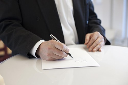 Man signing contract document